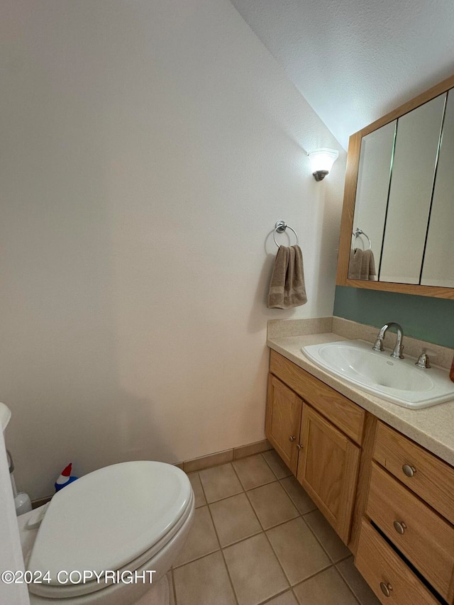 bathroom with vanity, tile patterned flooring, and toilet