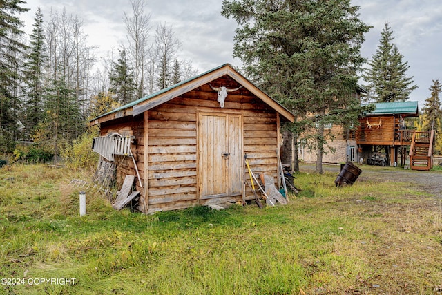 view of outbuilding featuring a lawn