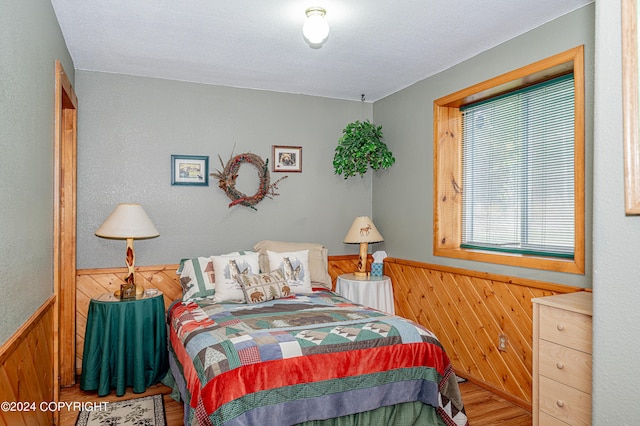 37325 Funny Moose Ln, Soldotna, AK 99669 - bedroom with wood walls, wood finished floors, and a wainscoted wall