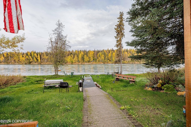 view of community featuring a lawn and a water view