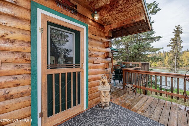 37325 Funny Moose Ln, Soldotna, AK 99669 - view of exterior entry featuring a deck and log siding