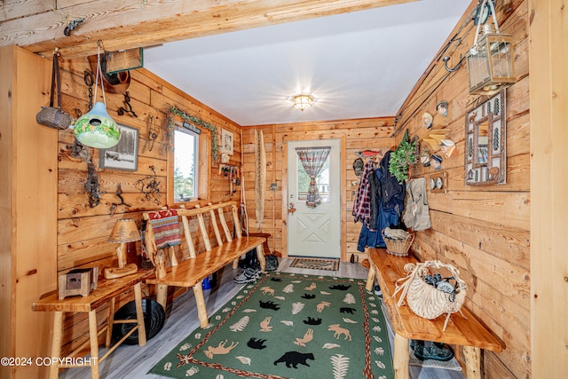 foyer with wood walls and hardwood / wood-style floors