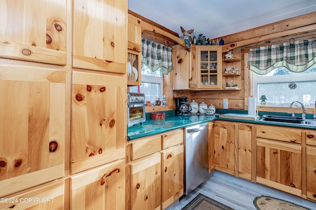 37325 Funny Moose Ln, Soldotna, AK 99669 - kitchen featuring stainless steel dishwasher, dark countertops, open shelves, glass insert cabinets, and light wood-type flooring