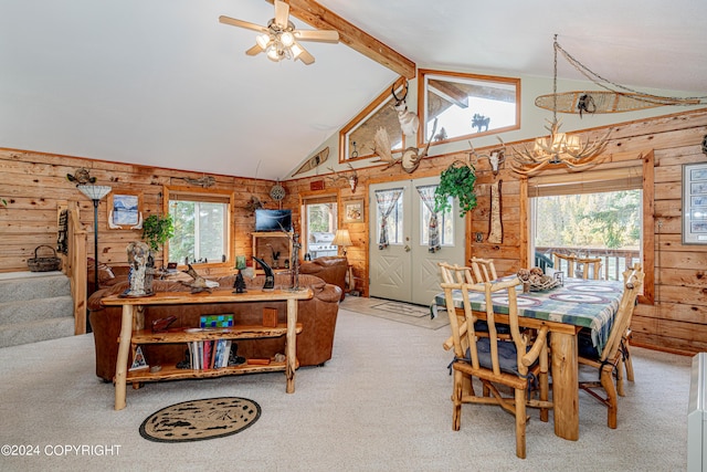 37325 Funny Moose Ln, Soldotna, AK 99669 - dining area with carpet, wood walls, a chandelier, a ceiling fan, and beamed ceiling