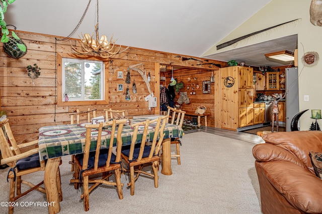37325 Funny Moose Ln, Soldotna, AK 99669 - carpeted dining space with lofted ceiling, wood walls, and a chandelier