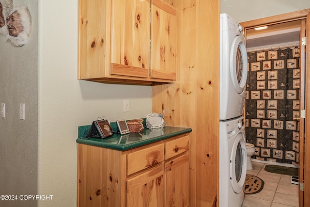 37325 Funny Moose Ln, Soldotna, AK 99669 - washroom featuring stacked washer and clothes dryer and light tile patterned floors