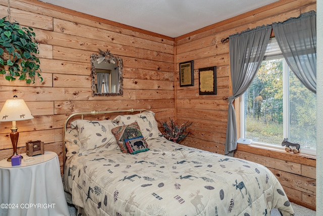 bedroom featuring wood walls