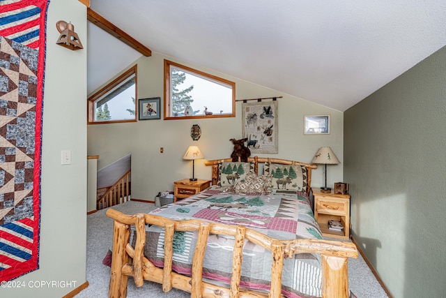 bedroom featuring lofted ceiling with beams and carpet