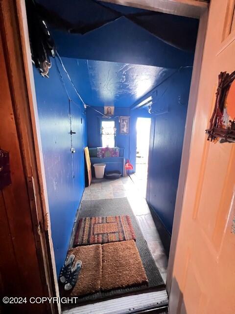 hallway with lofted ceiling