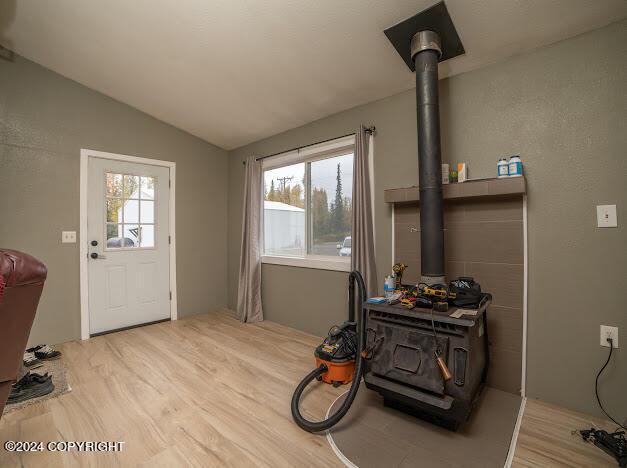 entryway featuring hardwood / wood-style flooring and lofted ceiling