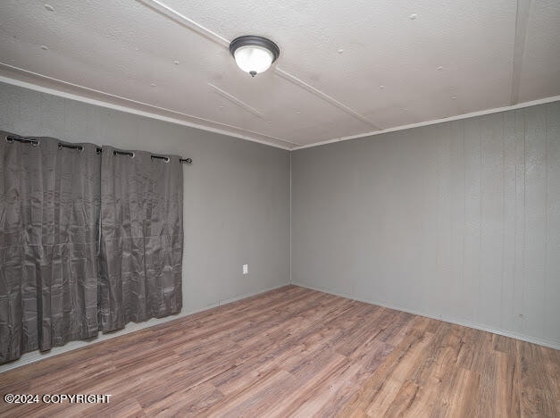 unfurnished room featuring hardwood / wood-style flooring