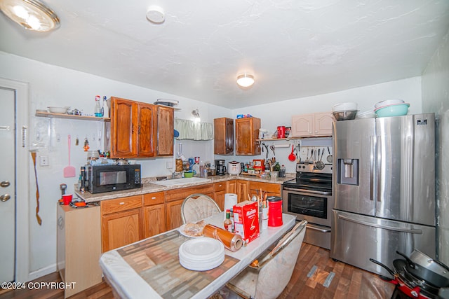 kitchen featuring sink, stainless steel appliances, and dark hardwood / wood-style flooring