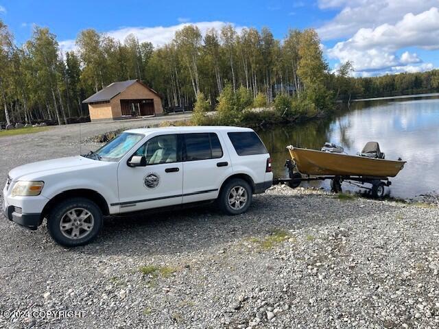 46689 S Fishermans Hop Rd # 6, Willow, AK 99688 - view of parking / parking lot featuring a wooded view and a water view