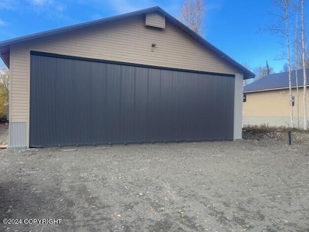 view of home's exterior with an outbuilding