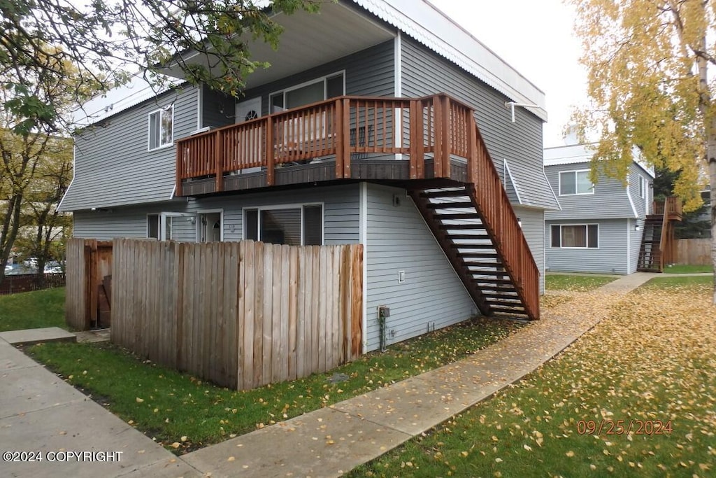 back of house featuring a wooden deck