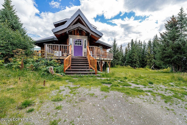 log cabin with a wooden deck