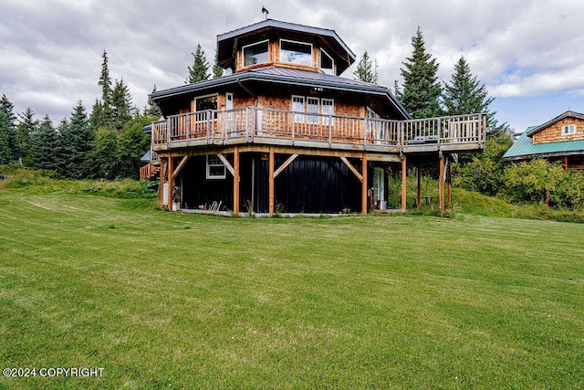 back of property featuring a wooden deck and a yard