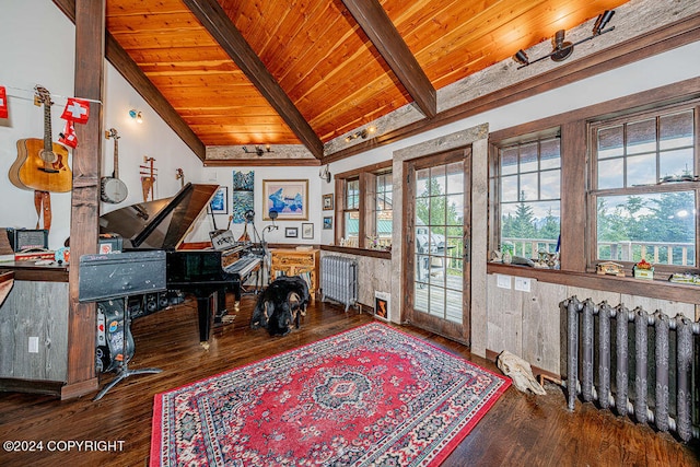 office area featuring hardwood / wood-style floors, radiator, lofted ceiling with beams, and a wealth of natural light