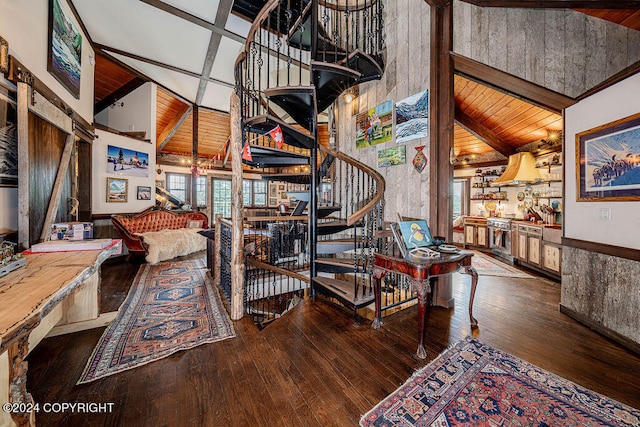 staircase featuring wood walls, hardwood / wood-style floors, and lofted ceiling with beams