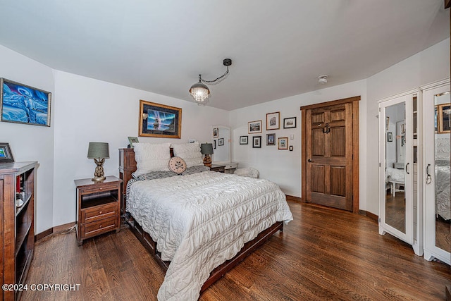 bedroom with dark hardwood / wood-style floors