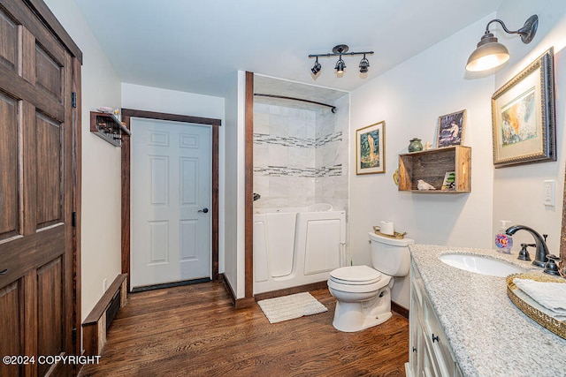 bathroom with vanity, hardwood / wood-style flooring, and toilet