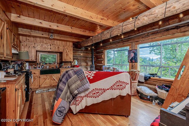 38126 Bobby Rufus Rd, Homer, AK 99603 - bedroom featuring wooden ceiling with exposed beams, light wood-style floors, and log walls