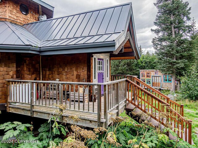 38126 Bobby Rufus Rd, Homer, AK 99603 - view of side of property with a wooden deck and metal roof