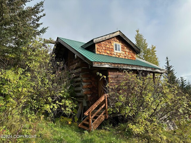 38126 Bobby Rufus Rd, Homer, AK 99603 - view of side of home with metal roof and log siding