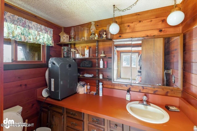 34464 Fishermans Rd, Soldotna, AK 99669 - bathroom with wood walls, toilet, and vanity