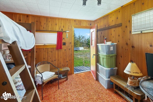 34464 Fishermans Rd, Soldotna, AK 99669 - bedroom featuring wooden walls, access to outside, and carpet