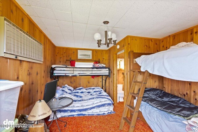 34464 Fishermans Rd, Soldotna, AK 99669 - carpeted bedroom featuring wooden walls and a chandelier