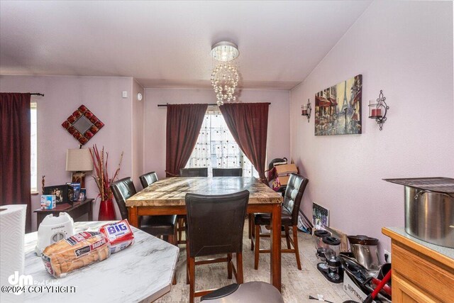 dining space featuring a chandelier and vaulted ceiling