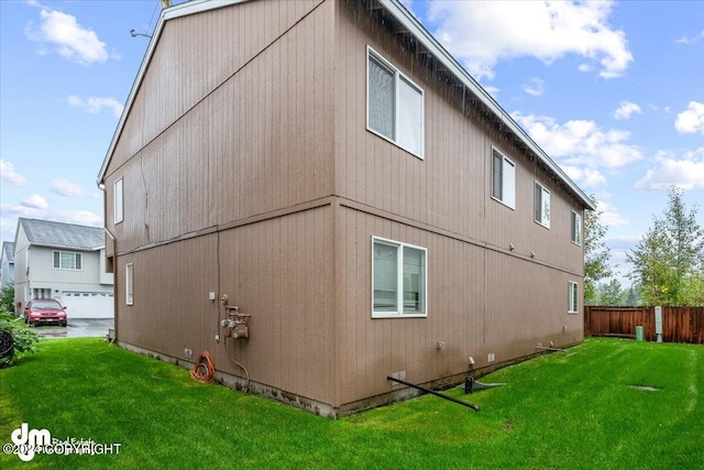 view of side of property with a lawn