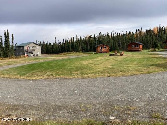 42781 Brenda Way, Soldotna, AK 99669 - view of green lawn with an outbuilding and a view of trees