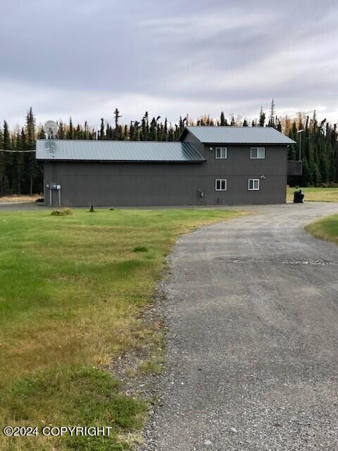 42781 Brenda Way, Soldotna, AK 99669 - view of property exterior featuring a metal roof and a lawn