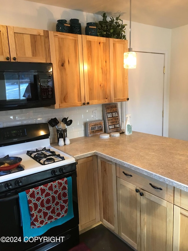 42781 Brenda Way, Soldotna, AK 99669 - kitchen with black microwave, gas range, light countertops, decorative light fixtures, and a peninsula
