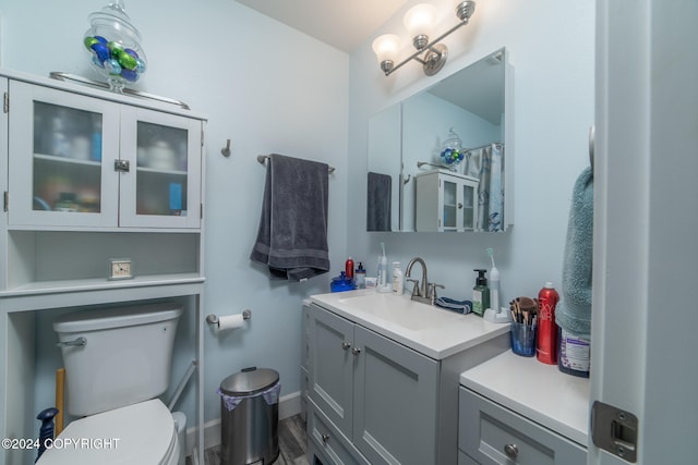 bathroom featuring hardwood / wood-style floors, vanity, and toilet