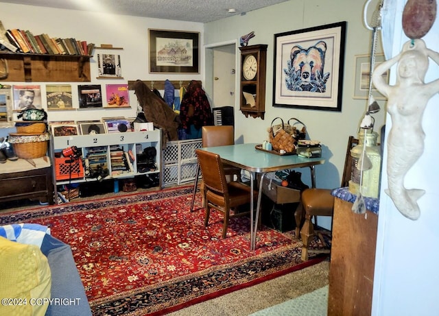 dining area featuring a textured ceiling and carpet flooring