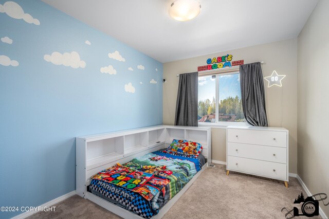 bedroom with carpet floors and baseboards