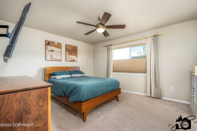 carpeted bedroom featuring ceiling fan and baseboards