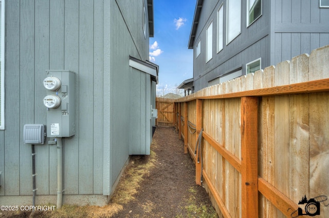 view of side of property featuring fence