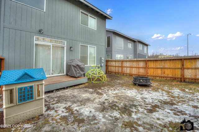 back of property featuring fence and a fire pit