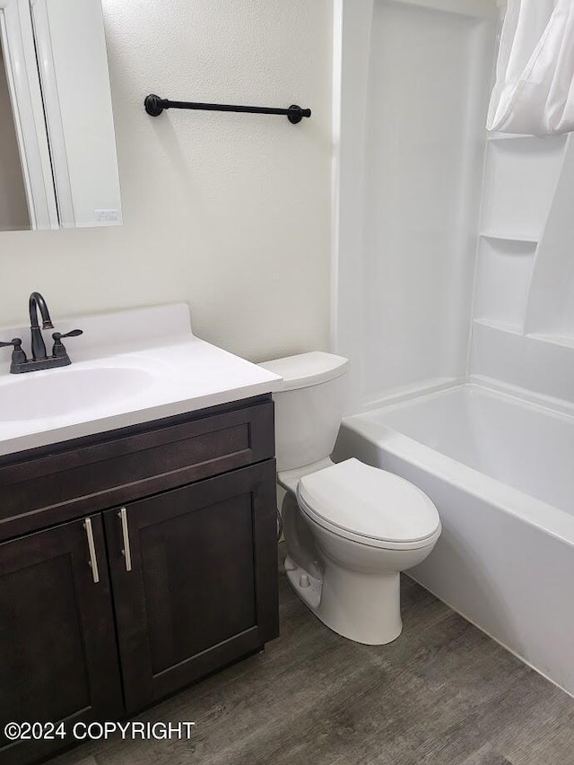 full bathroom with vanity, shower / bathing tub combination, toilet, and wood-type flooring