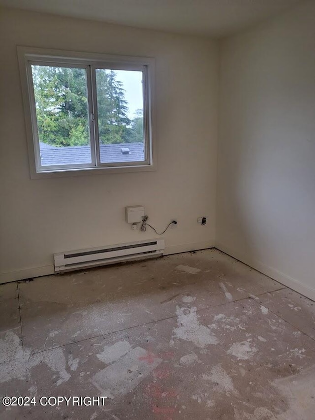 unfurnished room with a baseboard radiator