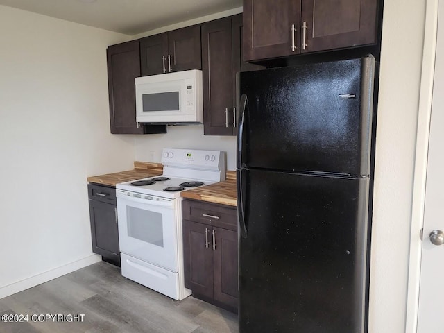 kitchen featuring light hardwood / wood-style floors, butcher block counters, dark brown cabinets, and white appliances