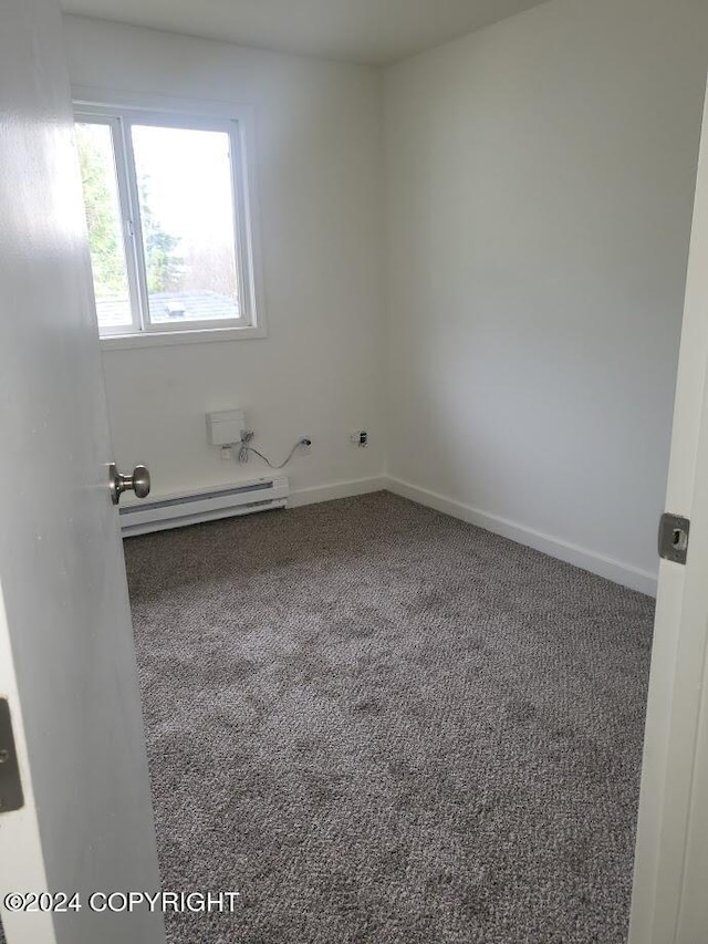 carpeted spare room with baseboard heating