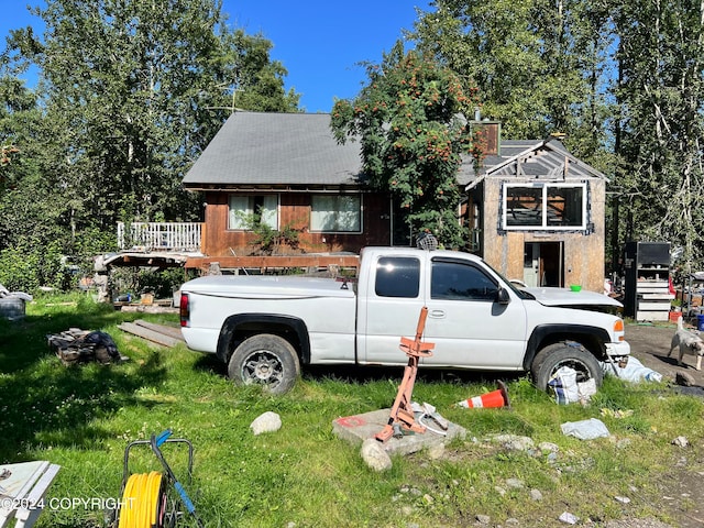 view of front of home featuring a front yard and a deck