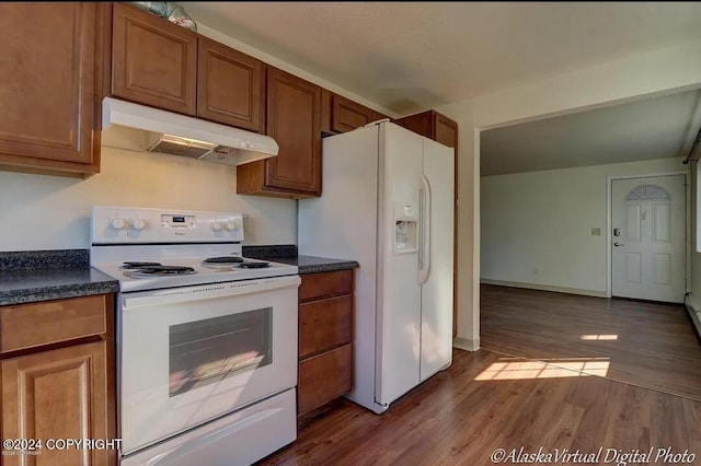 kitchen with hardwood / wood-style flooring and white appliances