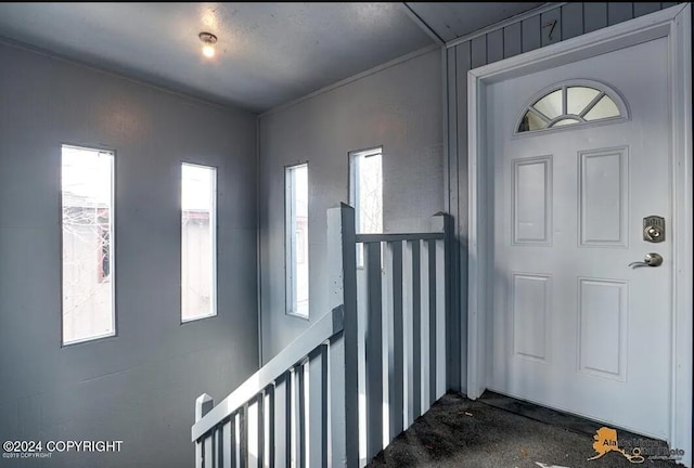 foyer entrance with a wealth of natural light and wooden walls