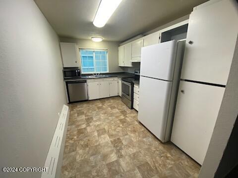 kitchen featuring white cabinets, sink, and appliances with stainless steel finishes